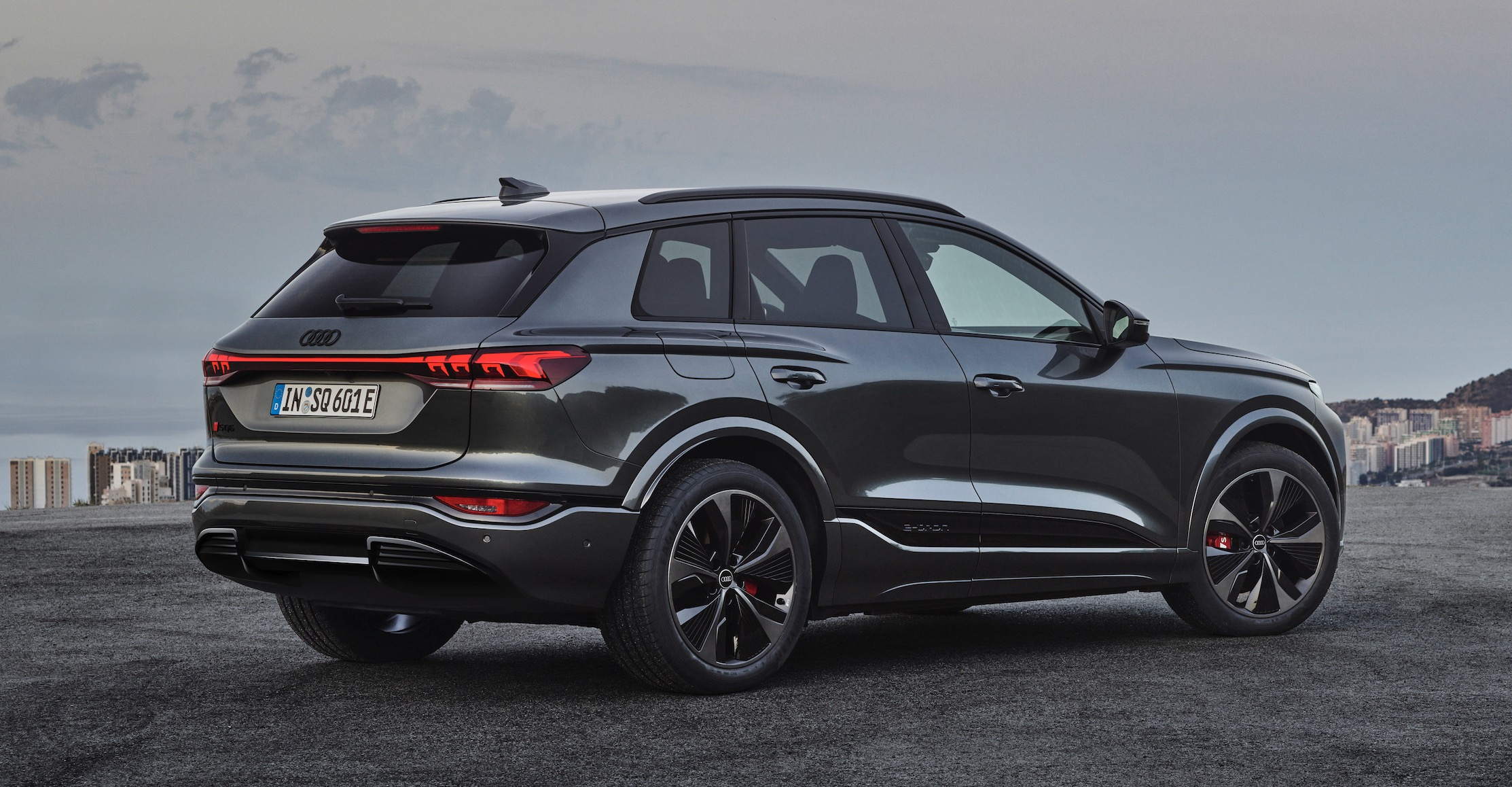 A black car parked on a road

AI-generated content may be incorrect.