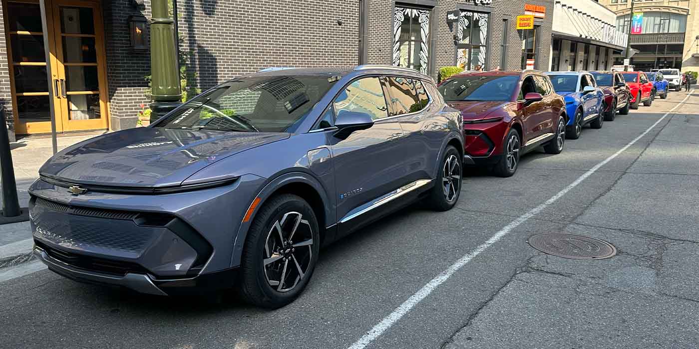 A group of cars parked on a street

Description automatically generated